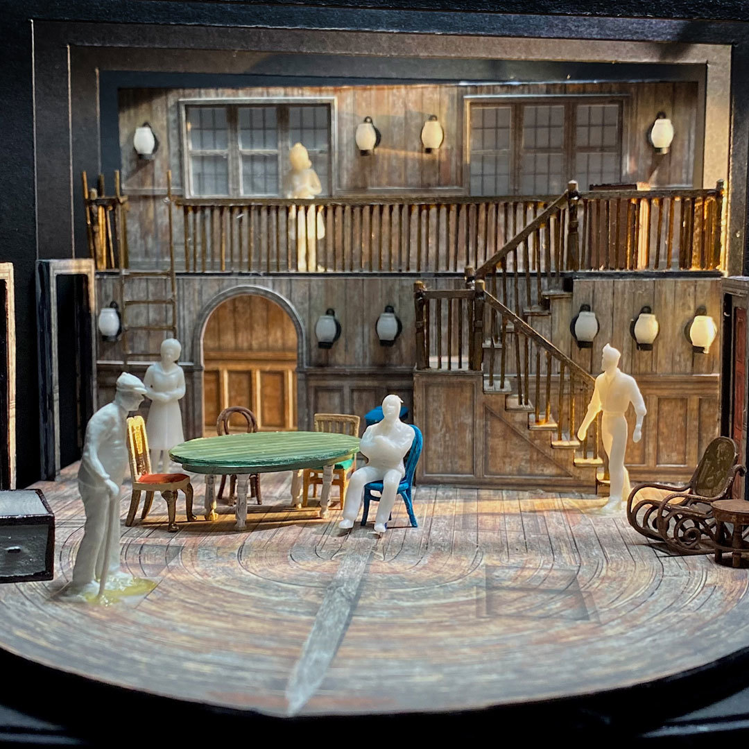 A full-color scale model of the scenic design for Gem of the Ocean, with scale-sized figures of people in the exposed interior of a house.