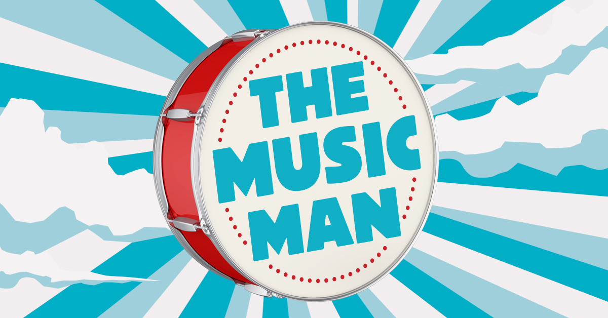 Title artwork with the words 'The Music Man' in ice-blue block capitals, centered in a red-rimmed bass drum and surrounded by radiant bands 