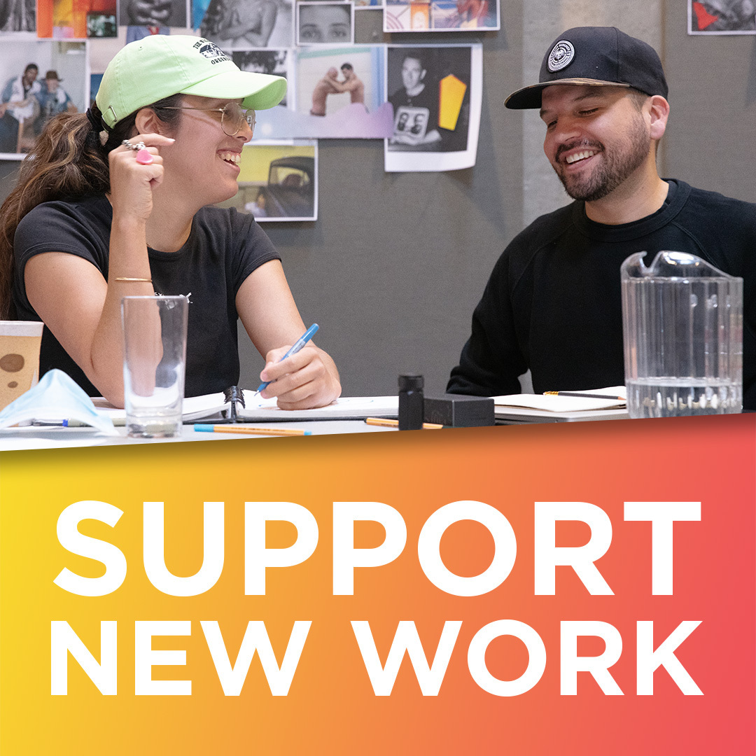 Above the words "Support New Work," two people sit smiling at each other at a work table covered with scripts and papers.