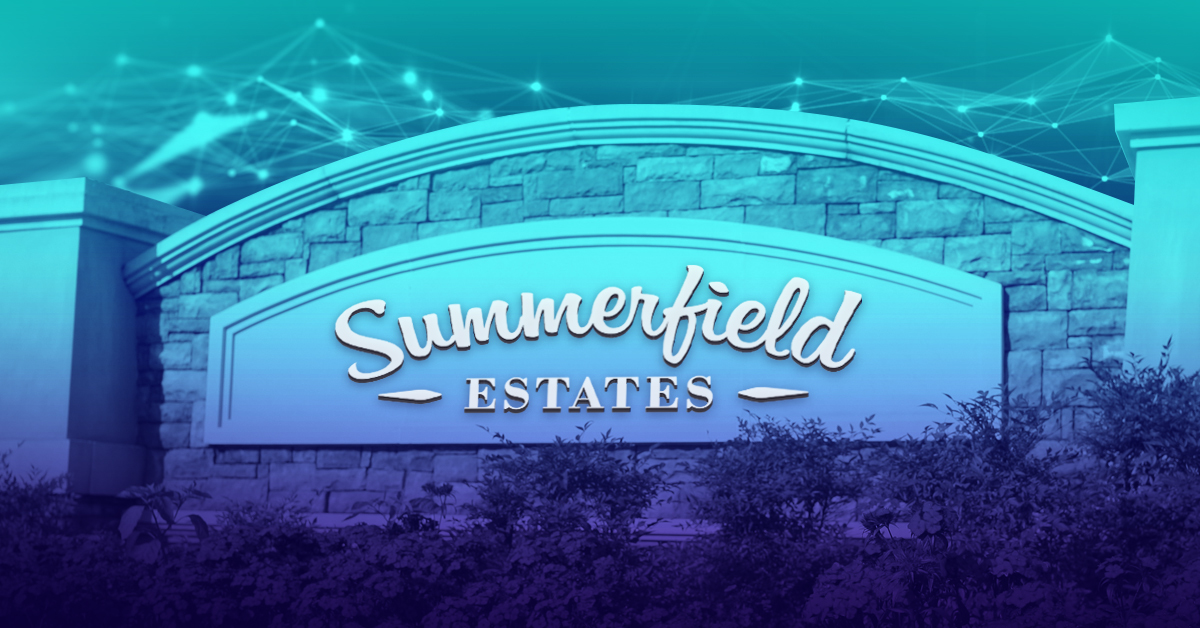 A sign reading "Summerfield Estates" on a stone wall of a retirement home.