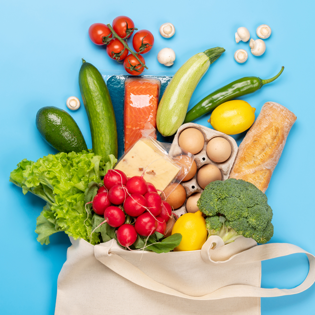 a canvas bag of groceries spilling over