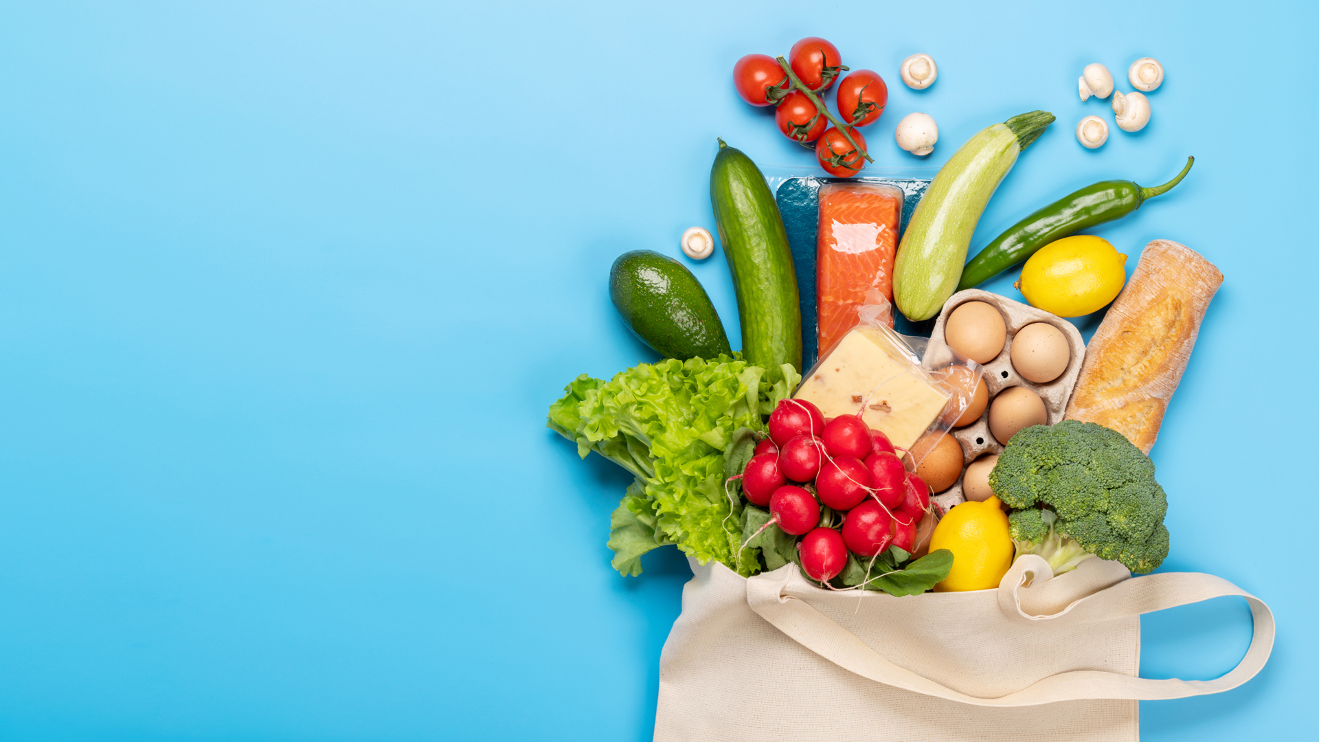 a canvas bag of groceries spilling over